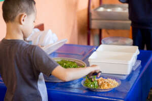 Student serving himself at lunchtime.