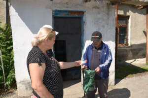 Angela Gives Igori Sputum Test Tubes