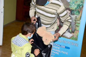 Daniel Peeks into His Bag with Father, Andrei
