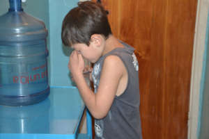 Holding his nose to swallow pills