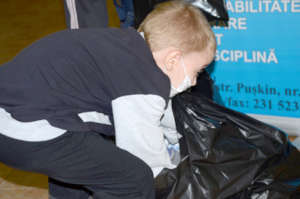 Serghei Retrieves Toy from His Bag