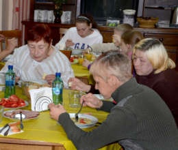 Liudmila (foreground) eats soup at Centre