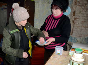 Liudmila takes anti-TB drugs from Galina