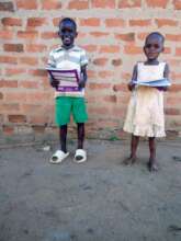 two orphans with book and pen each