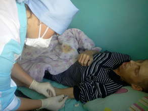 Performing injection to TB patient