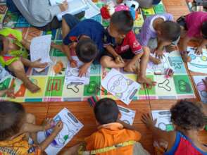Children color pictures at a workshop for parents