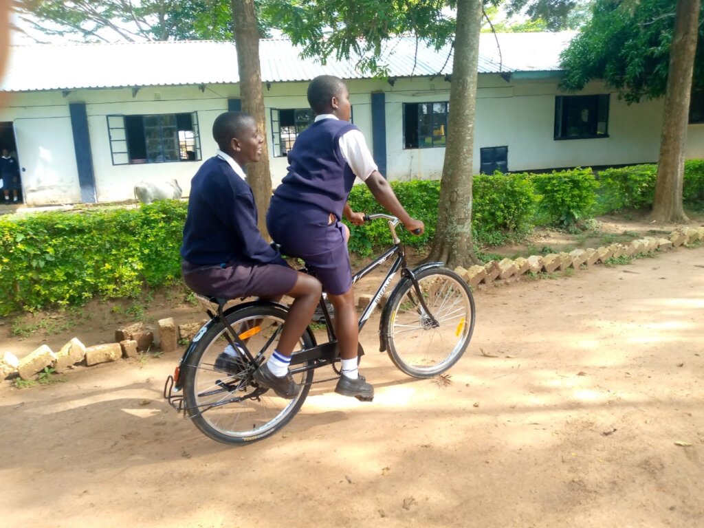 Girls Enjoying bicycle ride in new school unforms