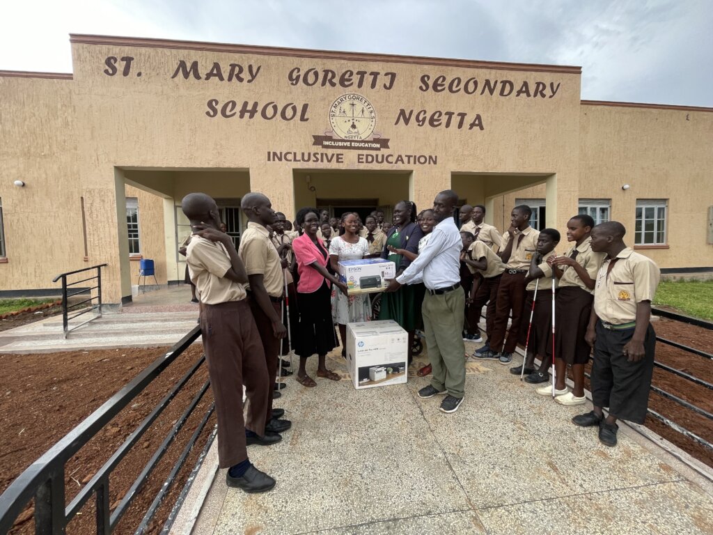 Staff and students receiving printers