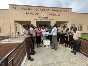 Staff and students receiving printers