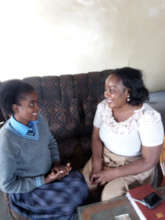 Girl discussing school with her healthcare worker