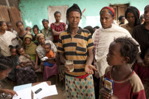 Adanech with her daughter receiving antibiotics