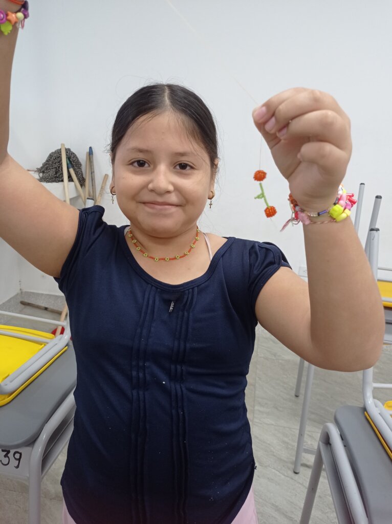 Sara is happy after finishing her artistic earring