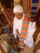 Weaving student shows her work