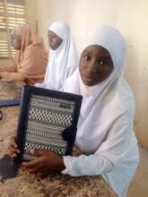 Leatherworking student shows her work