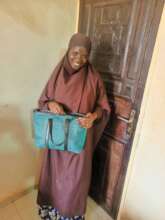 Leatherworking student with her project