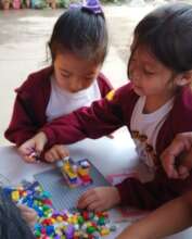 Girls building with Legos