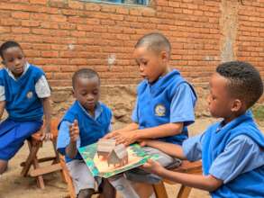 Elementary school students leaf through a children