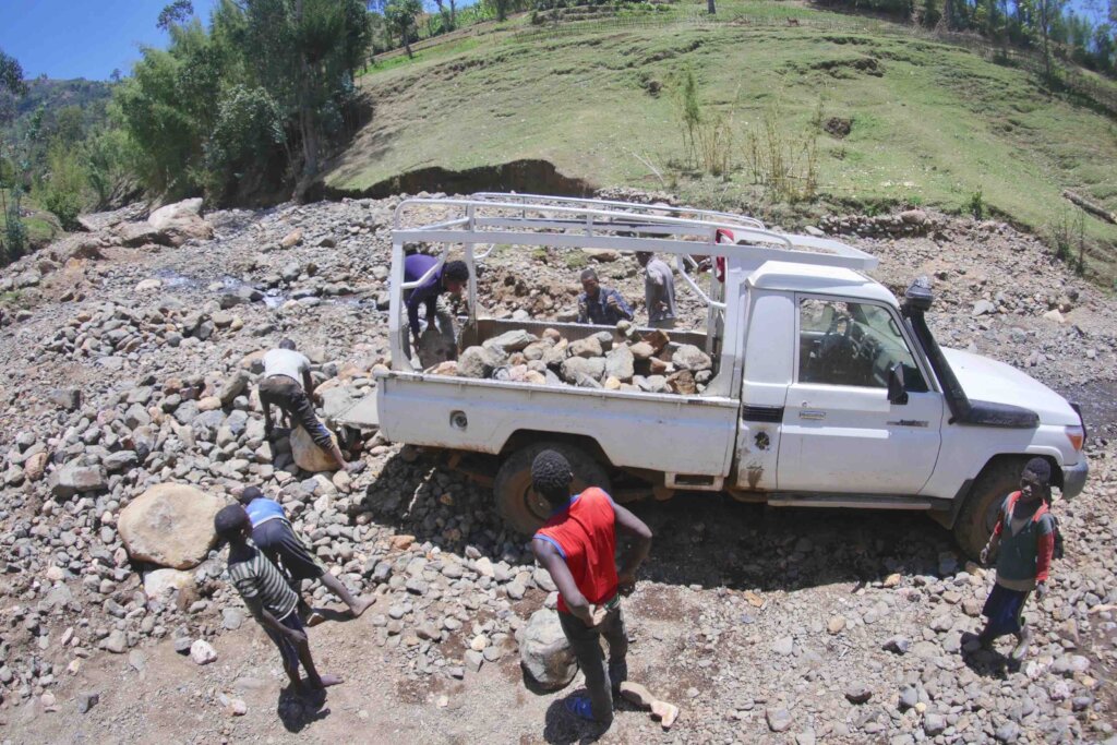 Community members collect local stones needed