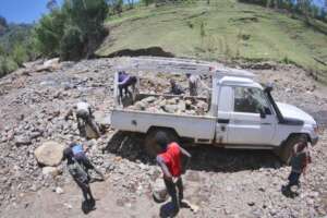 Community members collect local stones needed