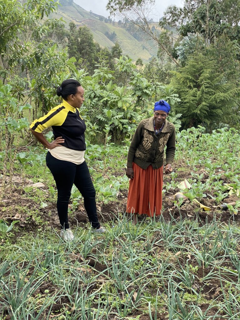 Woman shows HOPE staff her crops