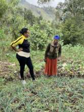 Woman shows HOPE staff her crops
