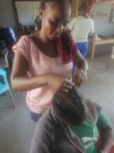 A beneficiary trained on beauty and salon skills