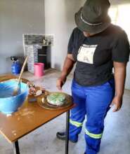 A beneficiary being trained on baking skills
