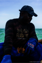 Community member attaching corals