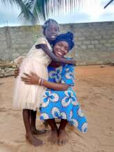 Family first! Two girls hugging in the courtyard