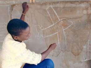 Future pilot draws an airplane on the chalkboard