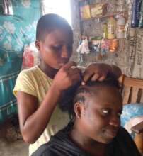 Future coiffeuse (hairstylist) braiding hair