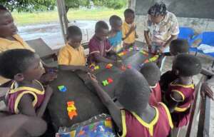 Blessing helping Kindergarten students.