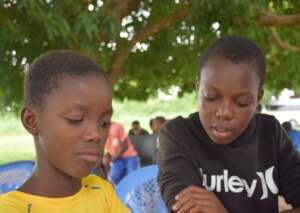 Isabel helping Philip with his reading