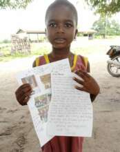 A student holds a letter from her sponsor