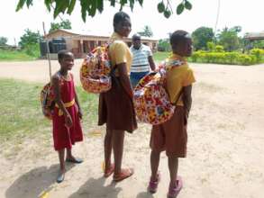 Sponsored students show off their new backpacks.