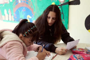 Natalia helping a child individually