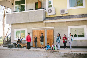Students and staff in front of our second building