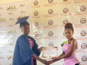 Rita receiving her certificate of completion.