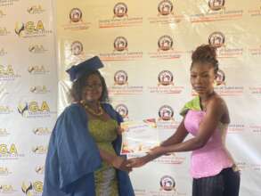Mercy receiving her certificate of completion.