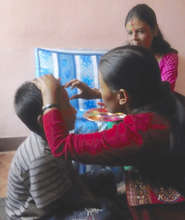 Nabin receives Tika from his new 'sister'