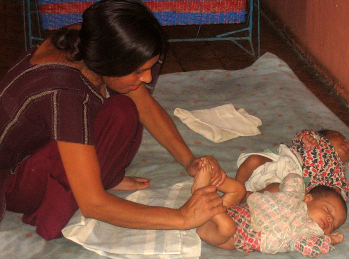 Trained GFV caregiver Mother "exercising" her baby