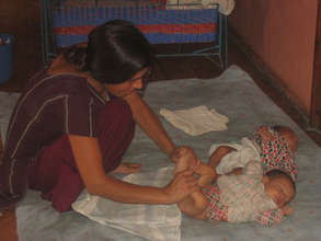 Trained caregiver "exercising" babies
