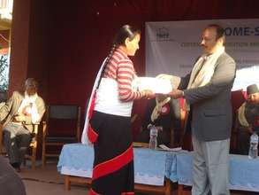 Farmer-woman graduating hospitality program.