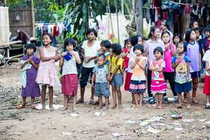 Children streaming out to see Visitors with gifts