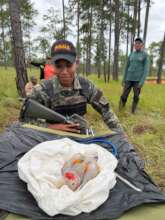 Solider with macaw chick in Honduras