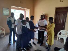 Students receiving scholarship chequess