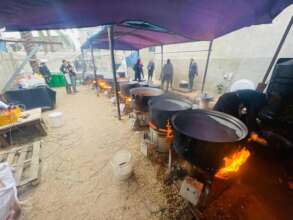 Food preparation with big cooking pots.