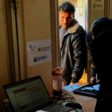 Aid workers check a man's ID during distribution.