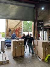Volunteers unloading winter shipment supplies in n