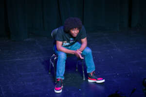 Student performs monologue on stage